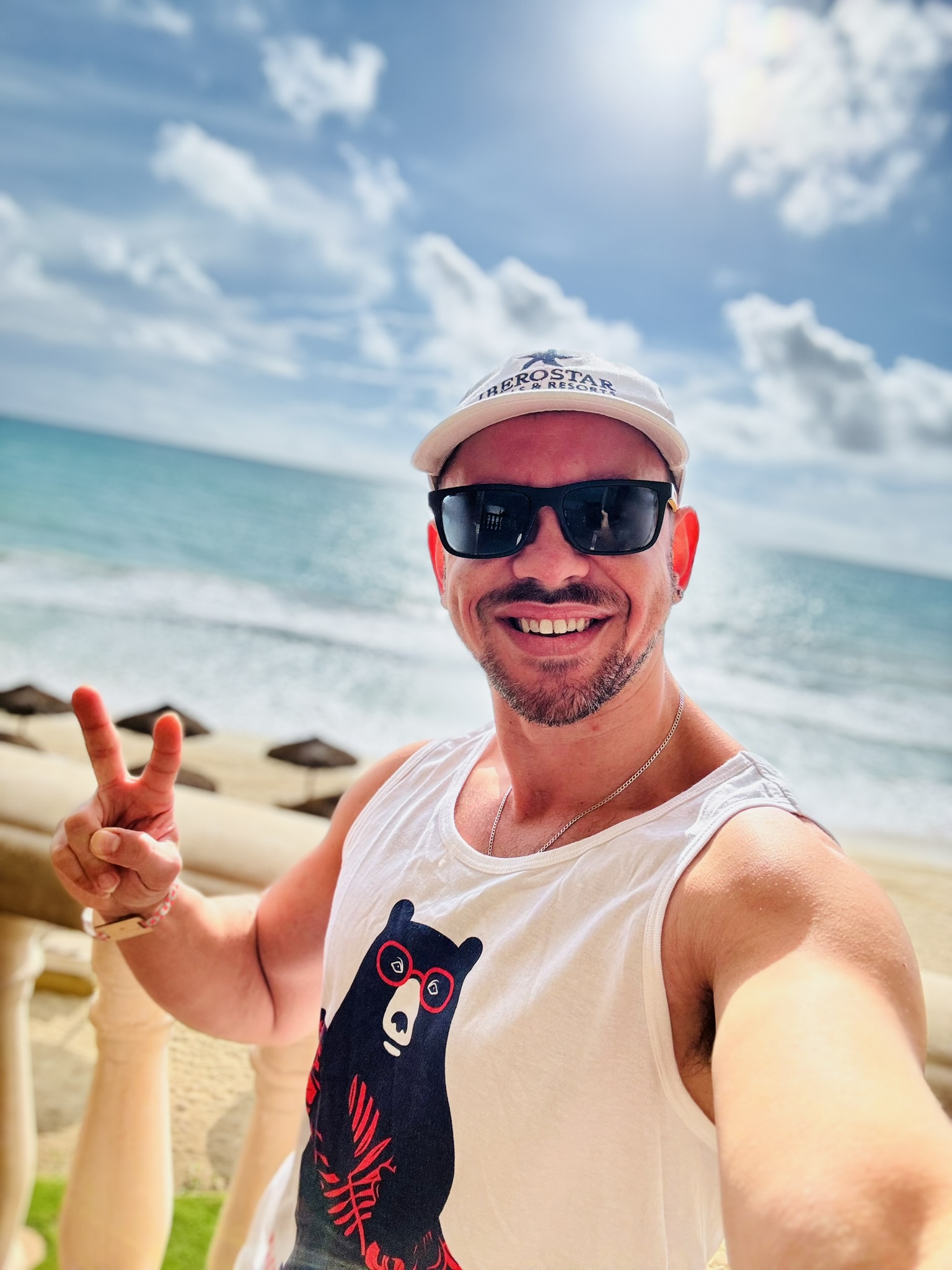 Mike at an Iberostar resort on the Caribbean coast, wearing an Iberostar Hotels & Resorts cap